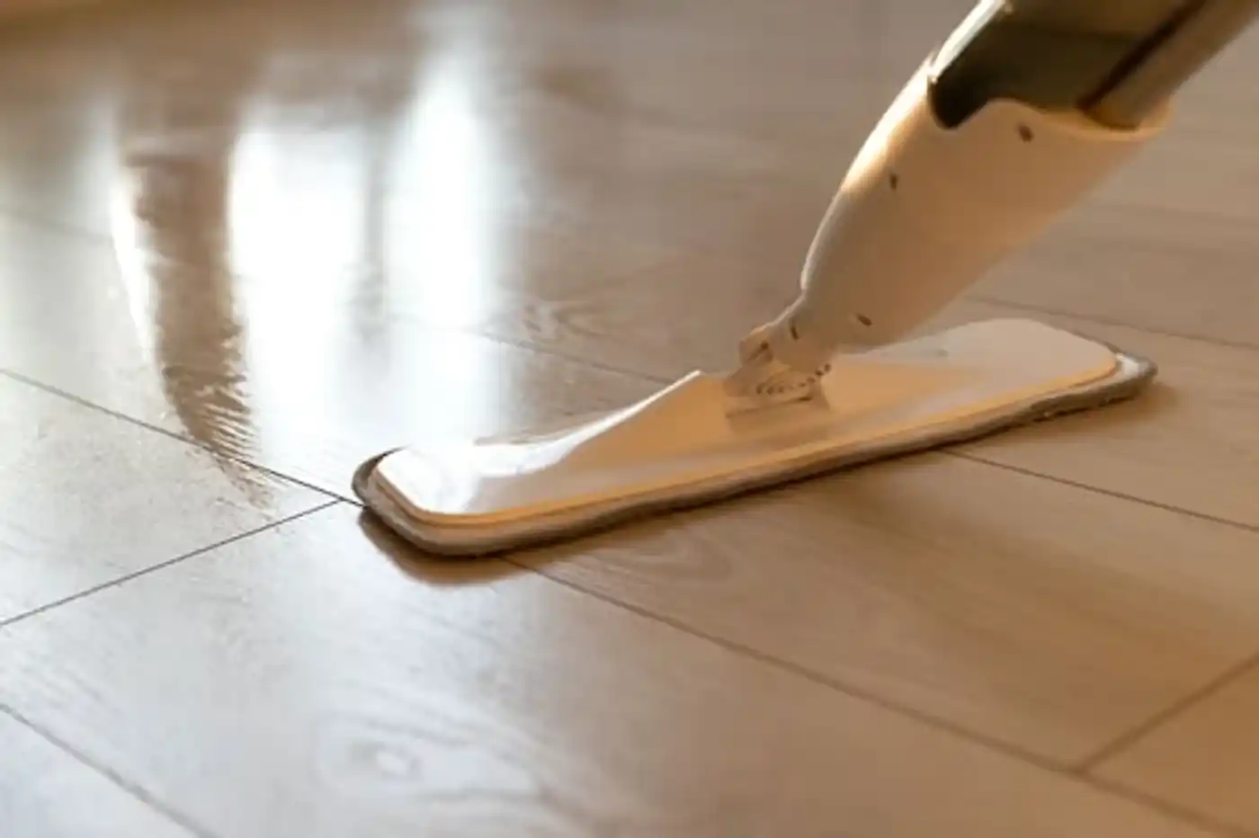 Mopping a glossy hardwood floor with a flat microfibre mop
